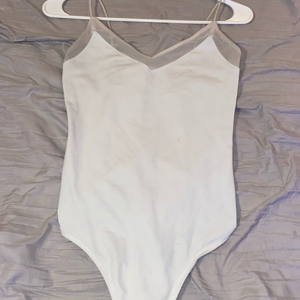 Very cute white body suit. Fits very nice to show curves. No rips, or stains.